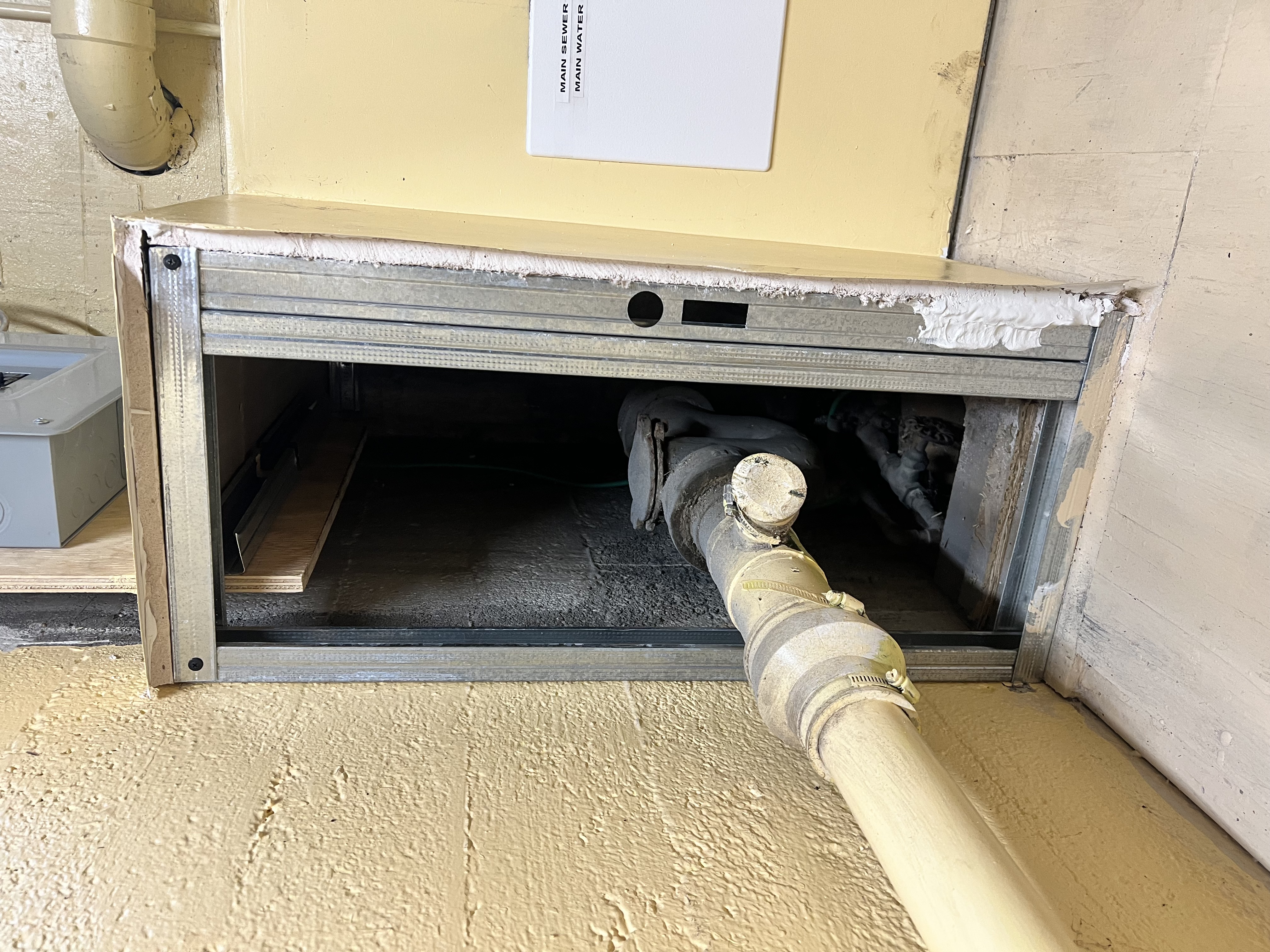 Before - exposed plumbing with no access cover